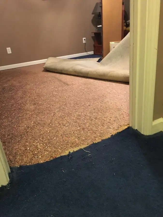 Carpet pad removal revealing water damage during Water Mitigation Services in Camp Pendleton Mainside